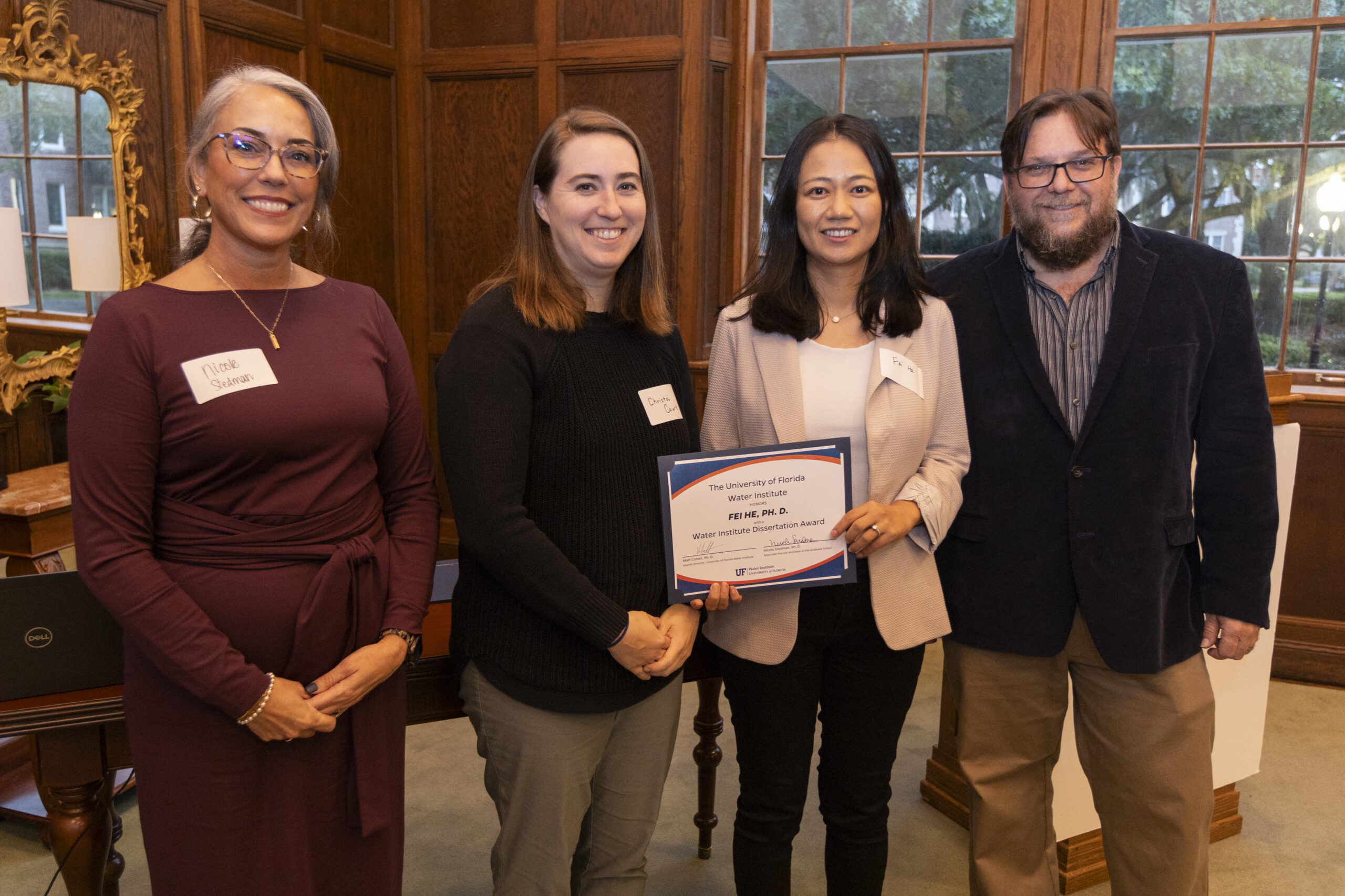 Dr. Fei He being presented with Dissertation Award