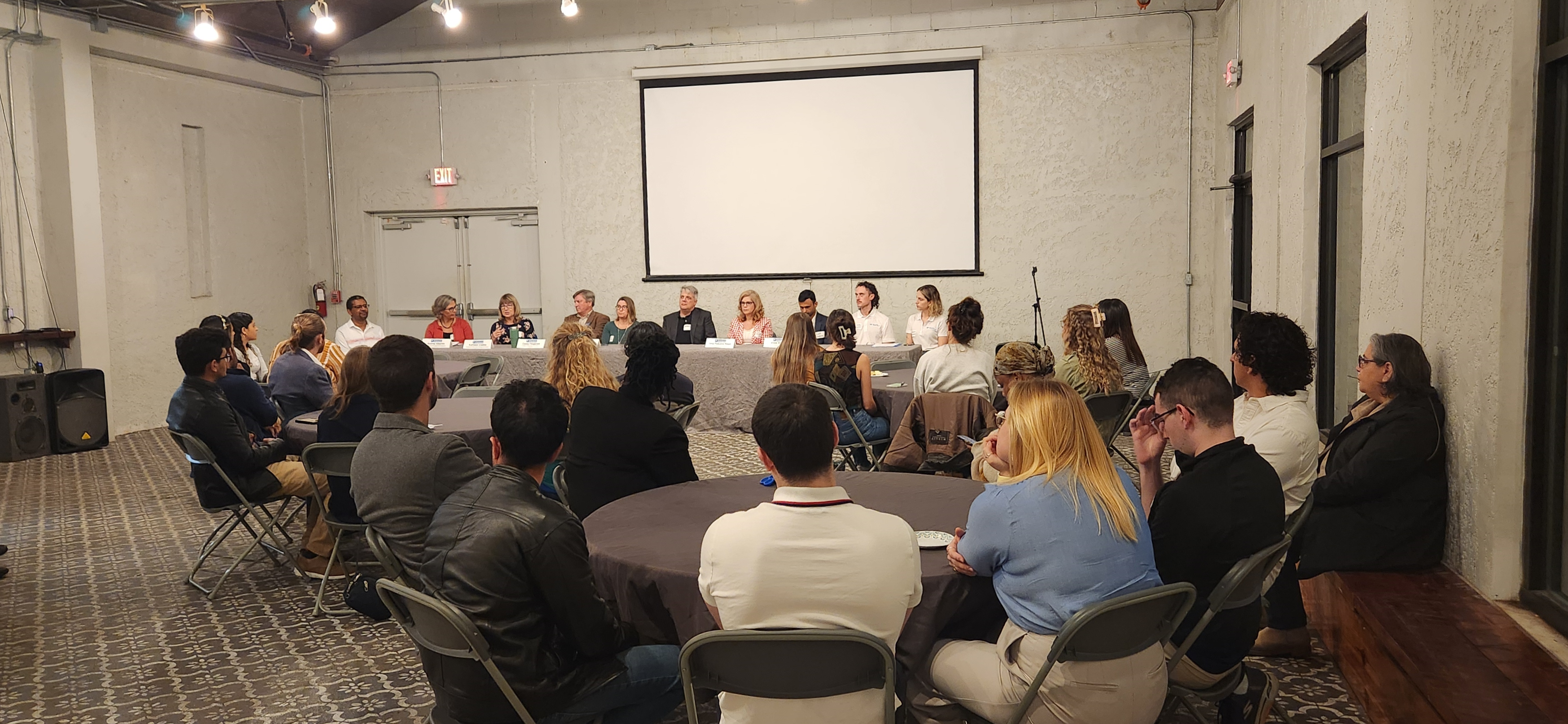 From left to right: Career Panelists Tirusew Asefa, Andrea Albertin, Kathleen Coates, Casey Fitzgerald, Stacie Greco, Jeffrey King, Gina Paduano Ralph, Vivek Shama, and moderators Paul Donsky and Gabrielle Quadrado. They are at a table in front of an audience of graduate students.
