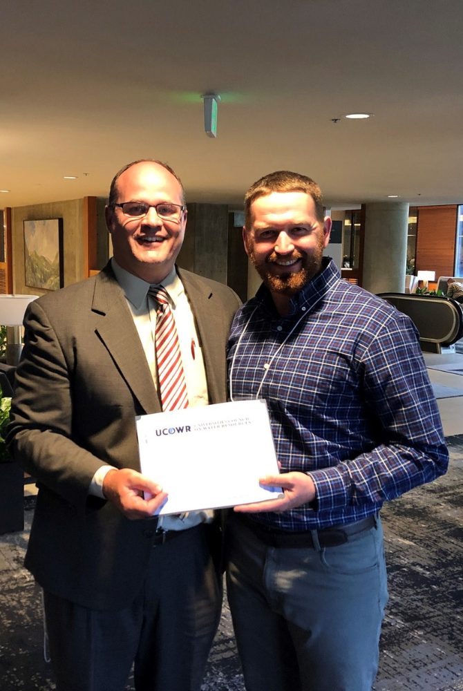 Dissertation Award recipient holding award.